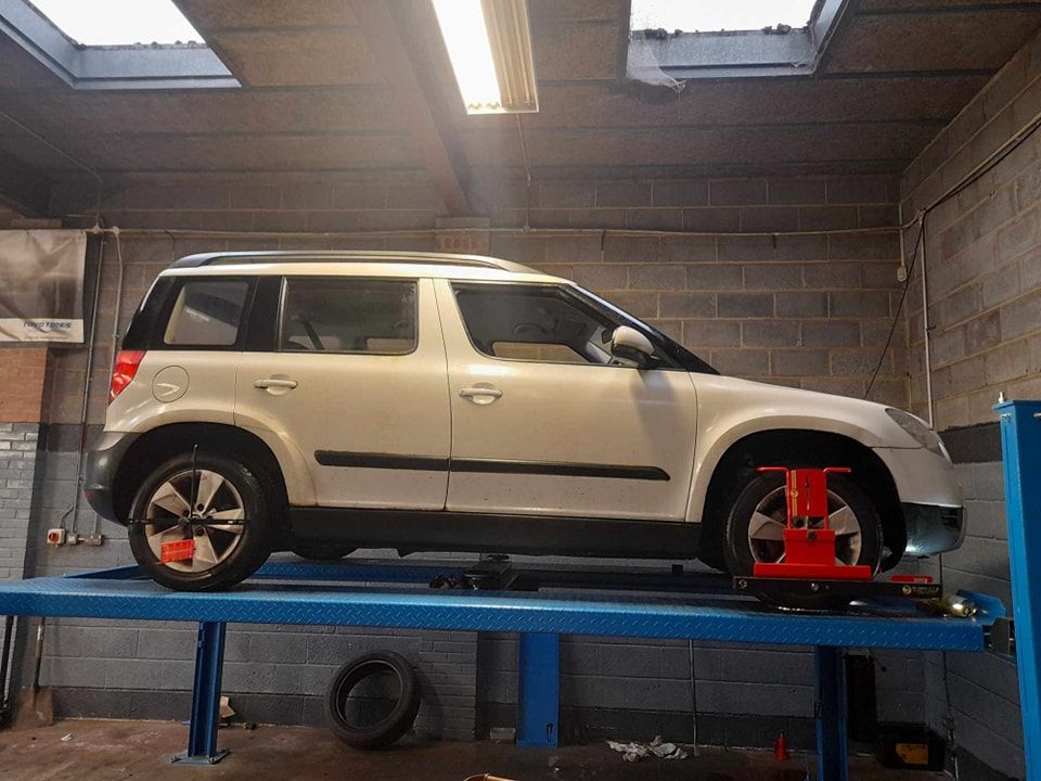Vehicle on a ramp waiting to have all 4 of its wheels aligned - Wheel Alignment Prudhoe